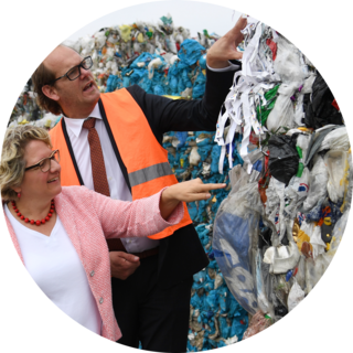 North Rhine-Westphalia summer tour with Svenja Schulze12 July 2018, Germany, Gescher: Federal Environmental Minister Svenja Schulze (L) Social Democratic Party (SPD), and Stephan Eing, CEO of “Eing Kunststoffverwertung”, standing during a visit of a facility for the sorting and recycling of plastic waste.